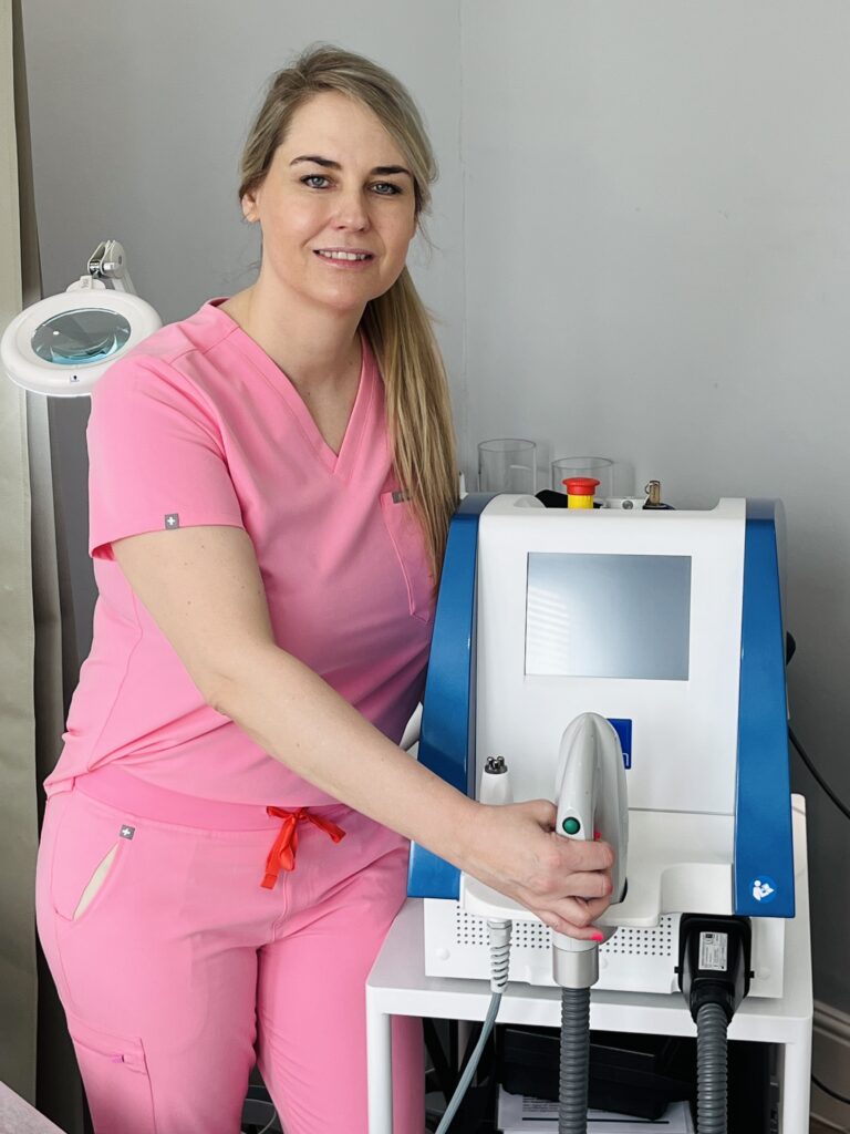IPL & Laser specialist standing next to IPL machine