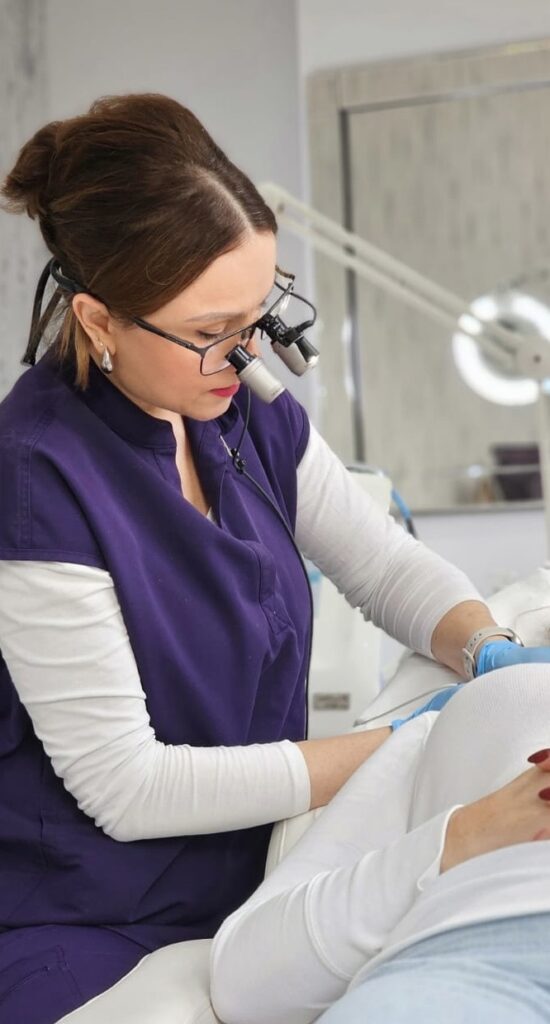 Skin specialist during the procedure of skin tag removal